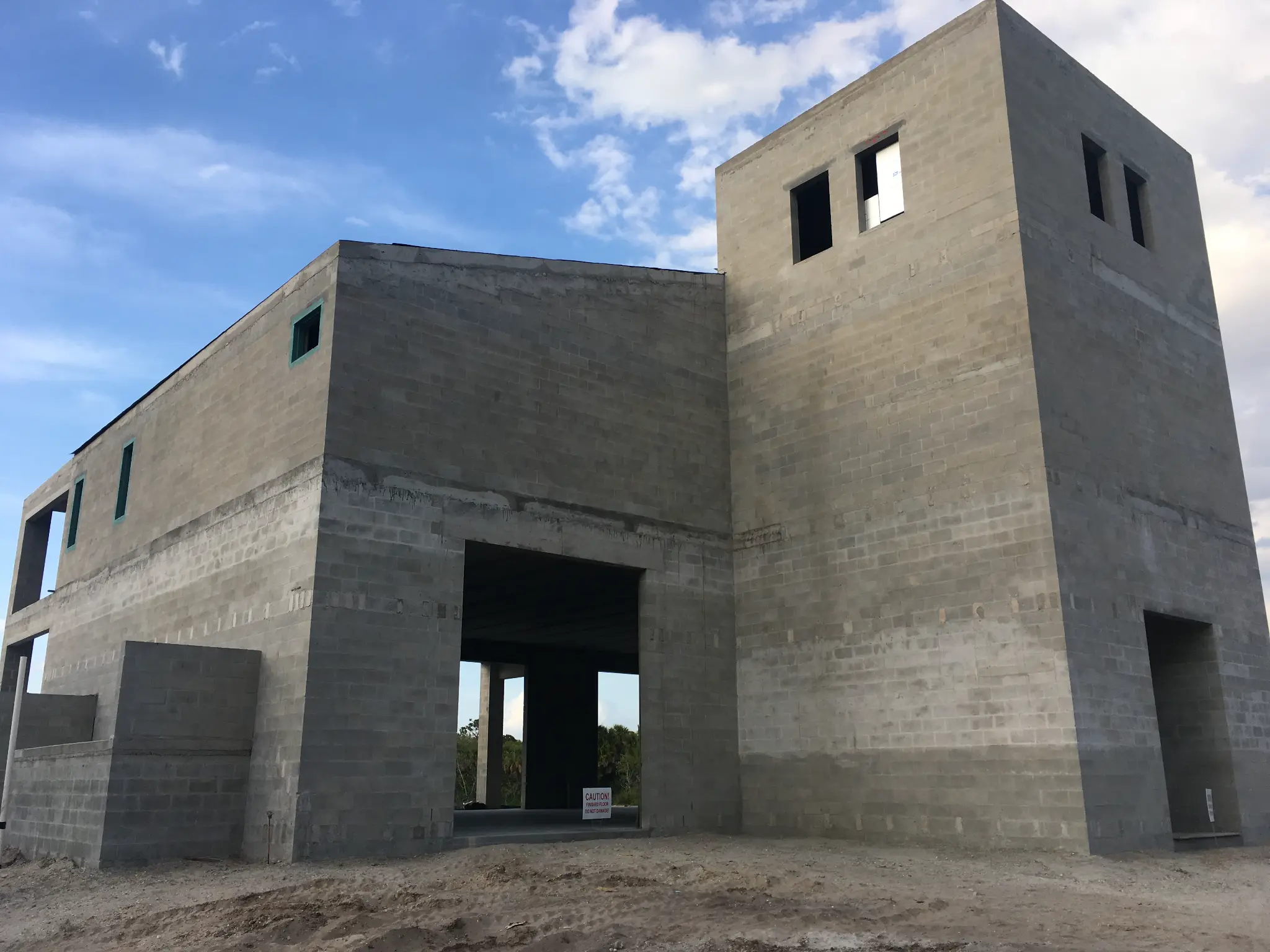 Concrete block building under construction with hollowcore roof